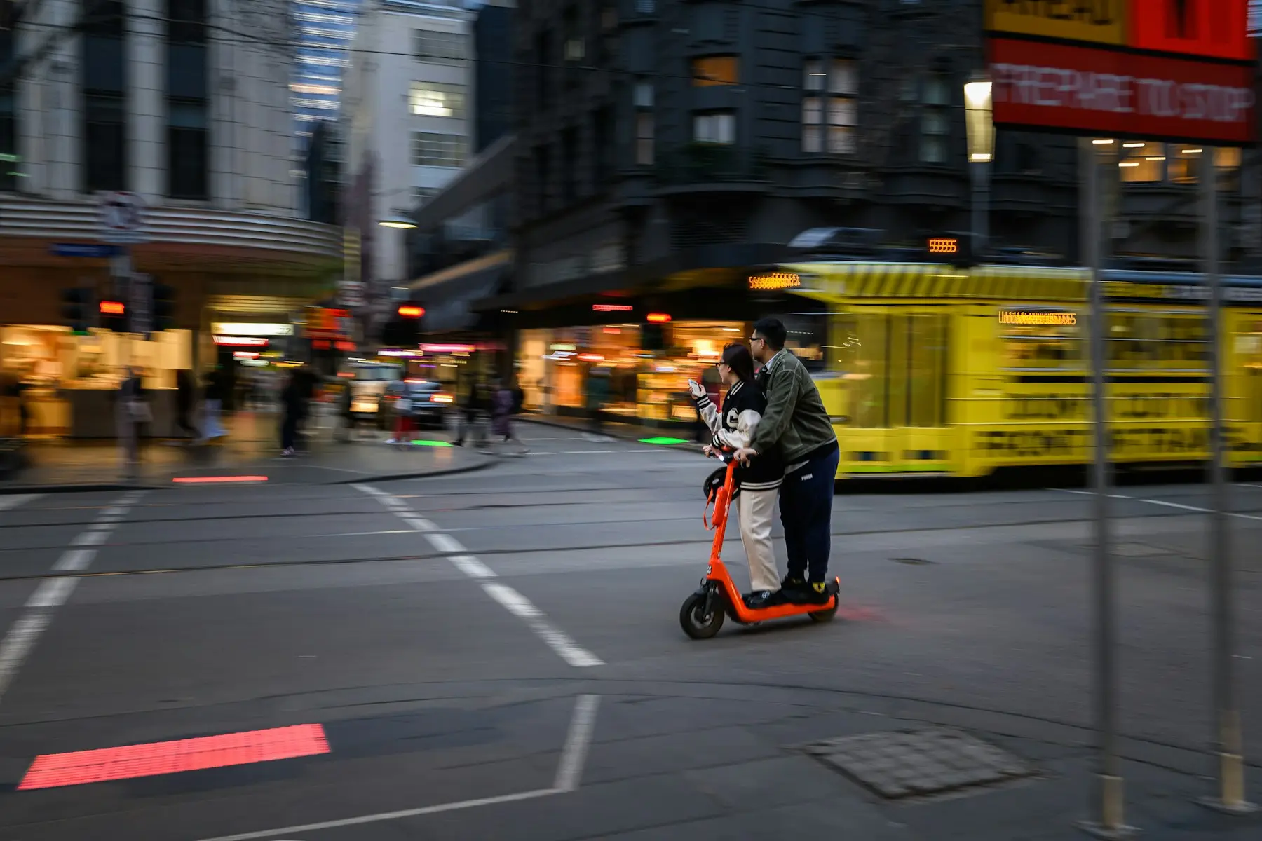 Persona en patinete eléctrico cruzando una calle de ciudad